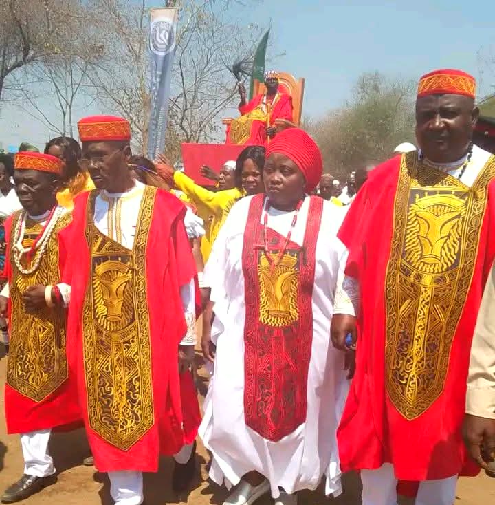 Mambwe royals and chiefs in red ceremonial regalia during a procession